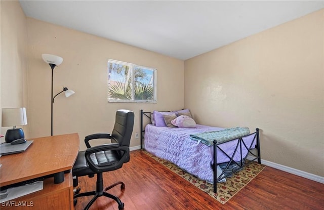 bedroom featuring dark hardwood / wood-style flooring