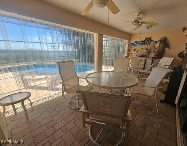 interior space with ceiling fan