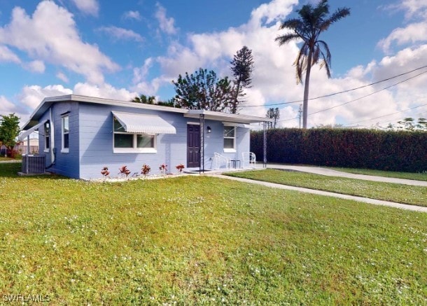 single story home with central air condition unit and a front yard