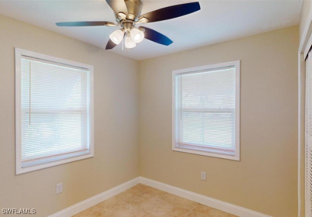 tiled empty room with ceiling fan