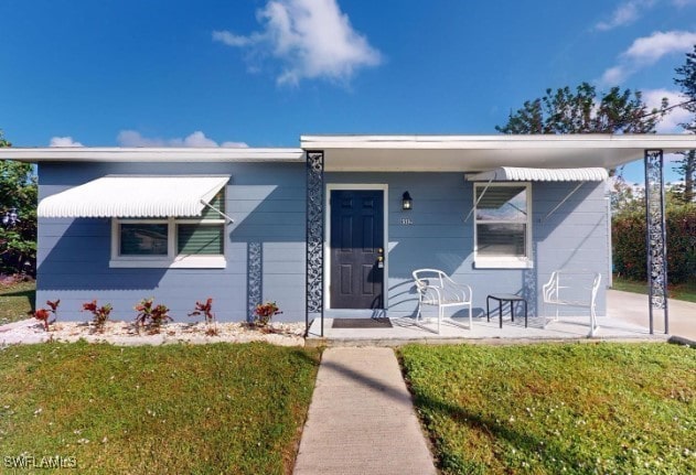 bungalow-style home featuring a front yard