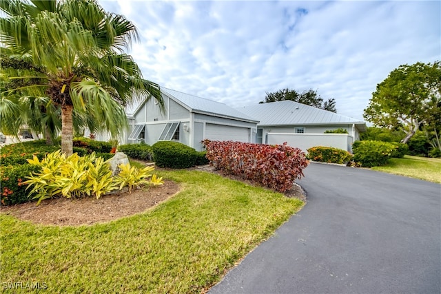 view of front of property with a front yard and a garage