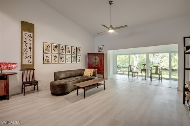 living room featuring light wood-type flooring, high vaulted ceiling, and ceiling fan