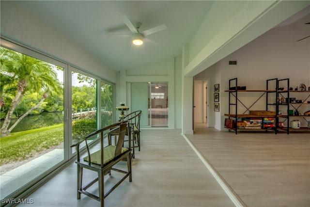 sunroom featuring ceiling fan and vaulted ceiling