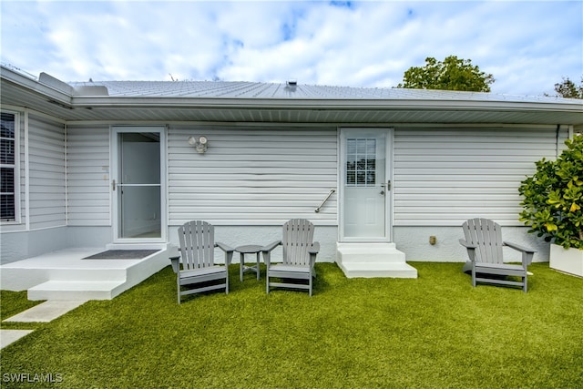 rear view of property with a lawn