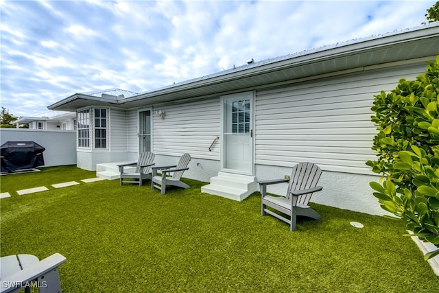 rear view of property with a lawn