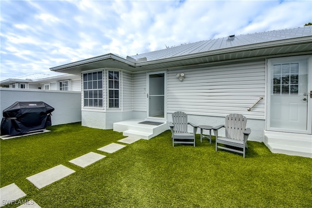 rear view of property featuring a yard