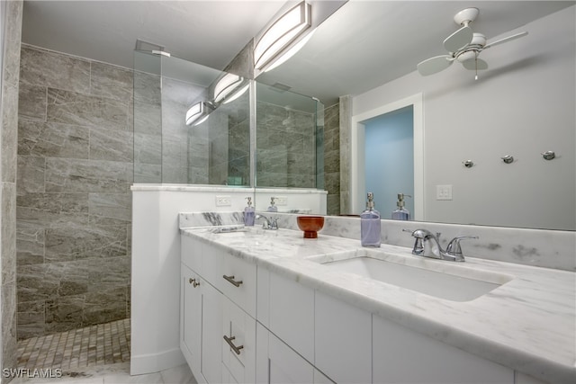 bathroom with vanity, ceiling fan, and tiled shower