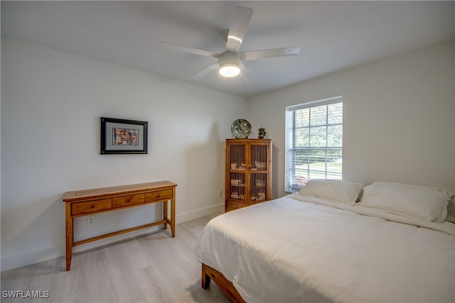 bedroom with light wood-type flooring and ceiling fan