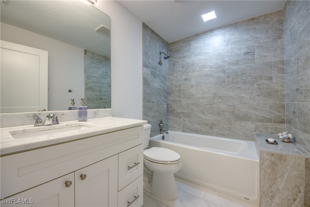 full bathroom featuring tile patterned flooring, vanity, toilet, and tiled shower / bath