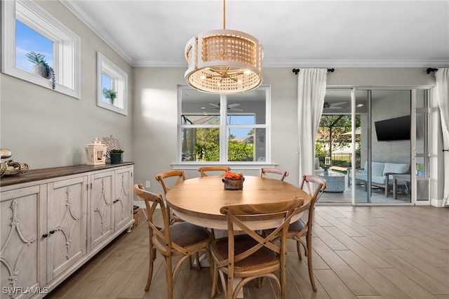 dining area with a notable chandelier, a healthy amount of sunlight, and crown molding