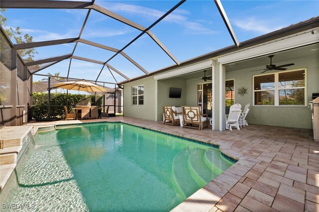 view of swimming pool featuring outdoor lounge area, a patio, ceiling fan, a lanai, and pool water feature