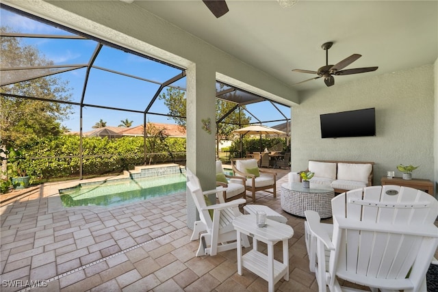 view of patio / terrace with ceiling fan, a lanai, and an outdoor living space