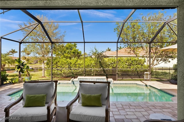 view of swimming pool with a patio area and a lanai