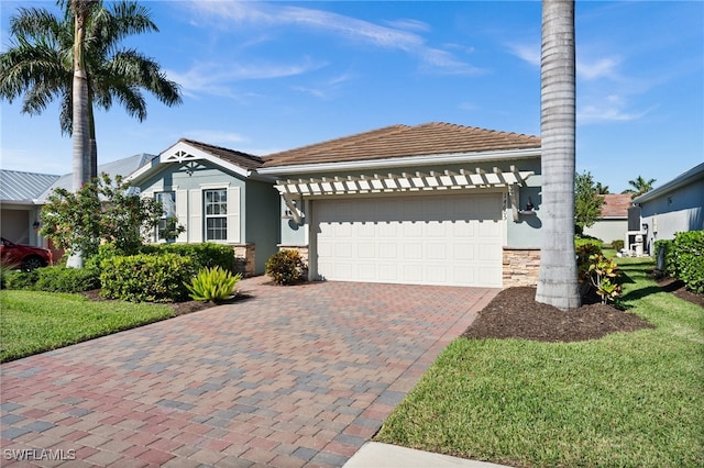 view of front of property featuring a garage and a front yard