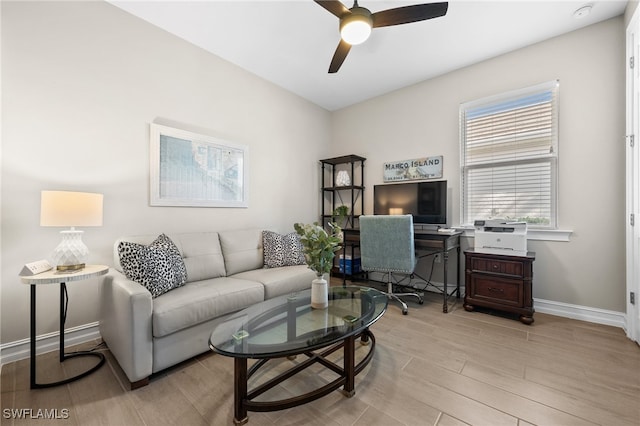 living room featuring ceiling fan and light hardwood / wood-style flooring