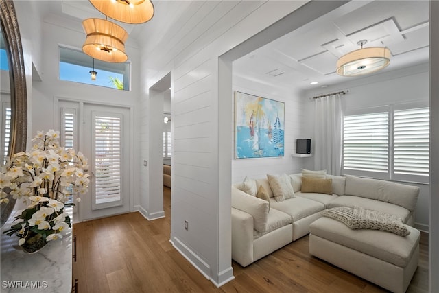 living room with plenty of natural light, hardwood / wood-style floors, and a high ceiling