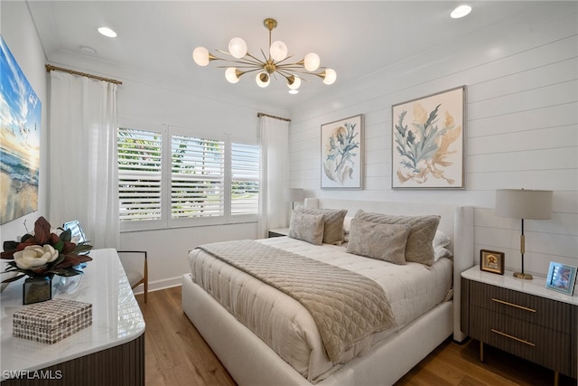 bedroom featuring dark hardwood / wood-style floors and an inviting chandelier