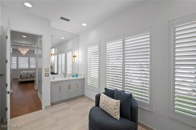 sitting room with light hardwood / wood-style floors and sink