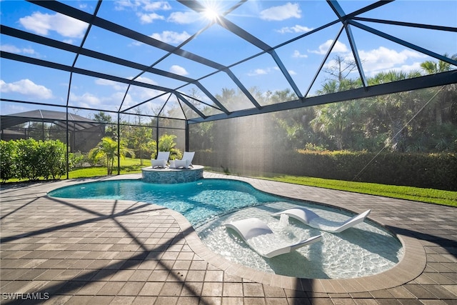 view of swimming pool featuring glass enclosure and a patio area