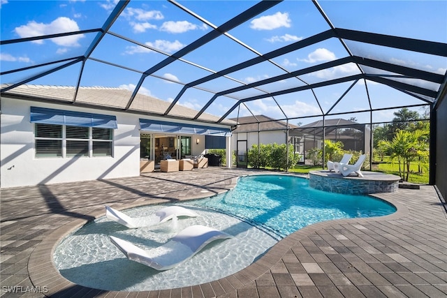 view of pool with glass enclosure and a patio