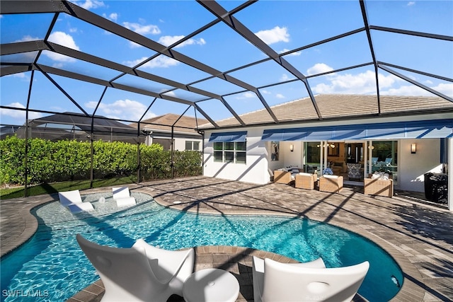 view of swimming pool with outdoor lounge area, glass enclosure, and a patio