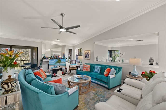 living room with ceiling fan, light wood-type flooring, lofted ceiling, and crown molding