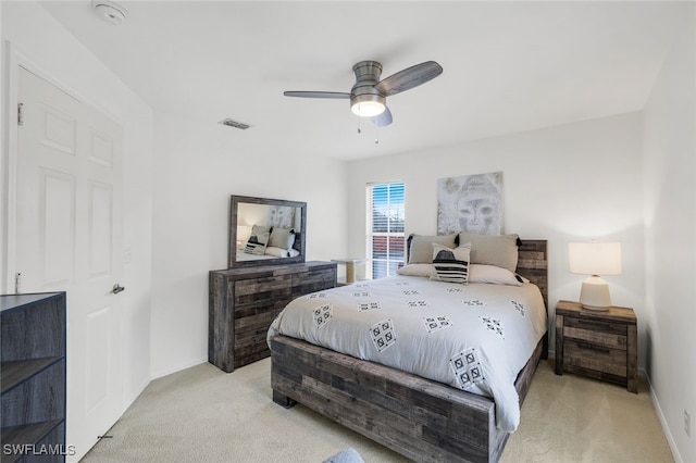 bedroom with ceiling fan and light carpet