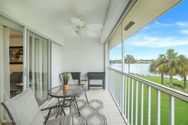 balcony featuring a water view and ceiling fan