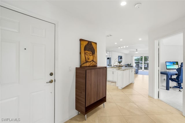 interior space with sink and light tile patterned floors