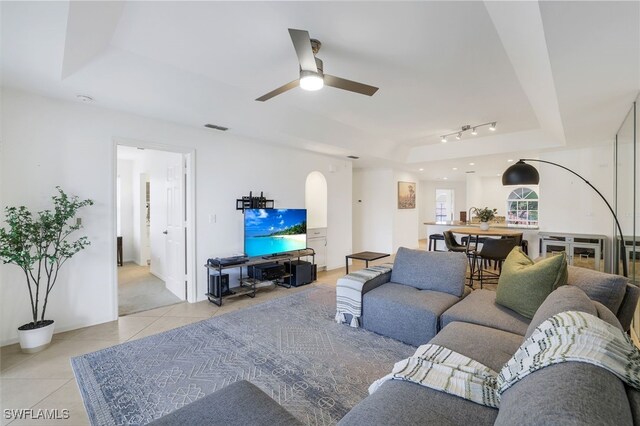 505 Mardel Dr Unit 112, Naples, FL 34104 - living area featuring a raised ceiling, light tile patterned floors, ceiling fan, and arched walkways