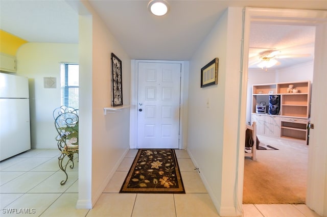 hallway featuring light colored carpet