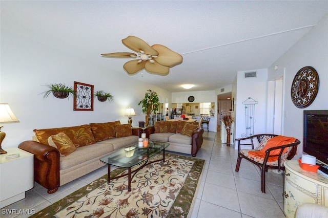 tiled living room with ceiling fan