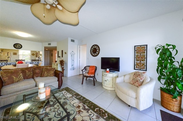 living room with ceiling fan and light tile patterned flooring