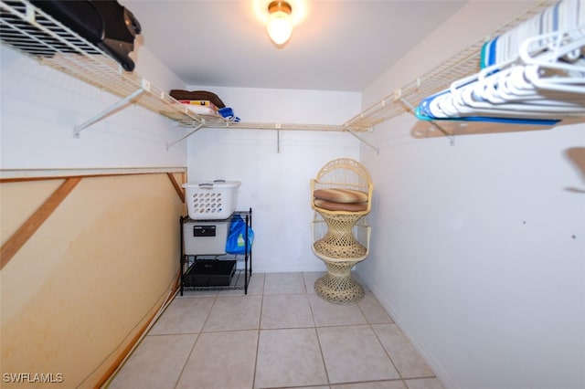 walk in closet with tile patterned floors