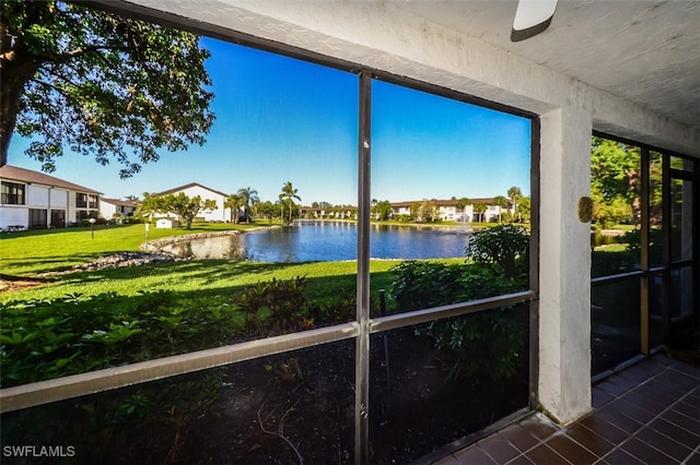 unfurnished sunroom featuring a water view