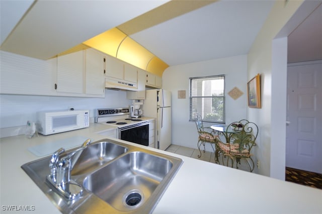 kitchen featuring white appliances, sink, and light tile patterned floors