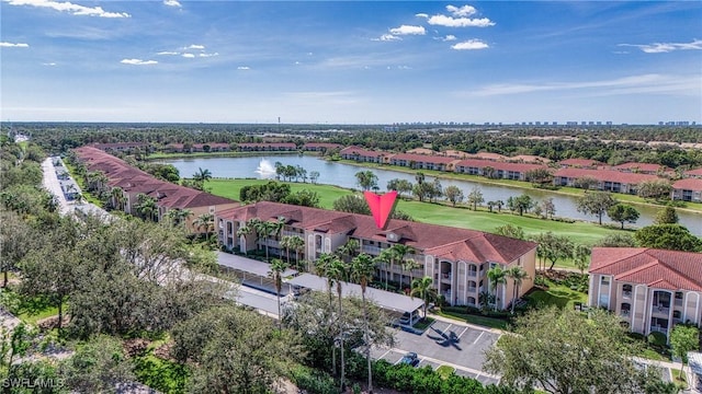 drone / aerial view featuring a water view and a residential view