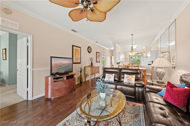 living room featuring crown molding, ceiling fan, and dark hardwood / wood-style floors