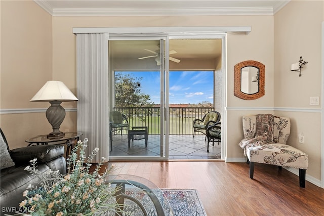 doorway featuring hardwood / wood-style floors, ceiling fan, and ornamental molding