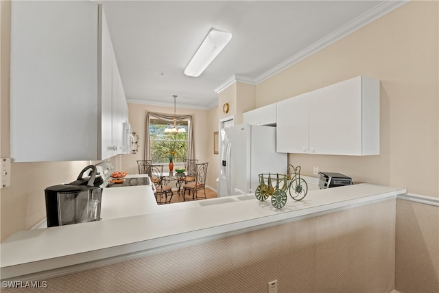 kitchen featuring white cabinetry, sink, hanging light fixtures, white appliances, and ornamental molding