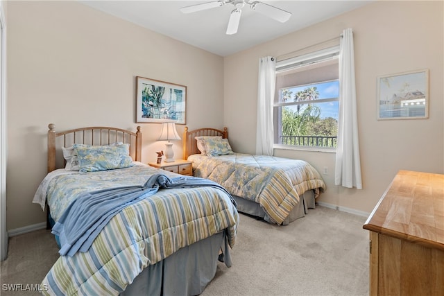 bedroom featuring light colored carpet and ceiling fan