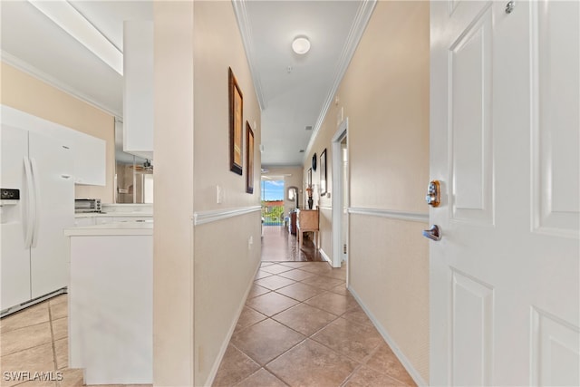 corridor featuring ornamental molding and light tile patterned floors