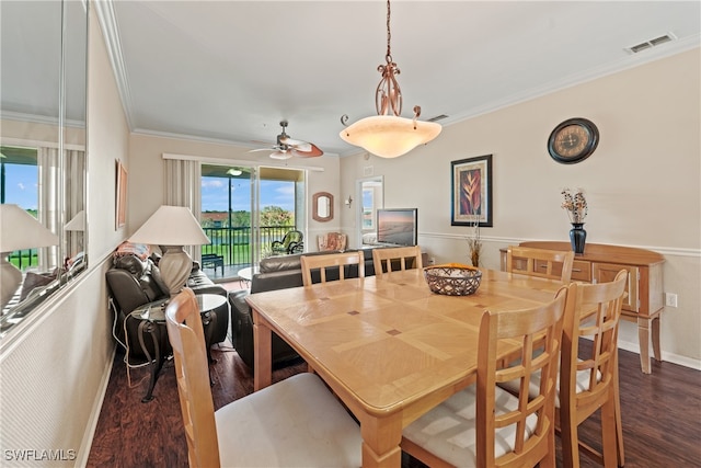 dining space featuring ceiling fan, dark hardwood / wood-style flooring, and crown molding