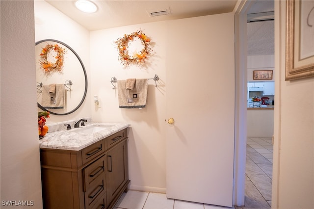 bathroom featuring tile patterned flooring, vanity, and a textured ceiling