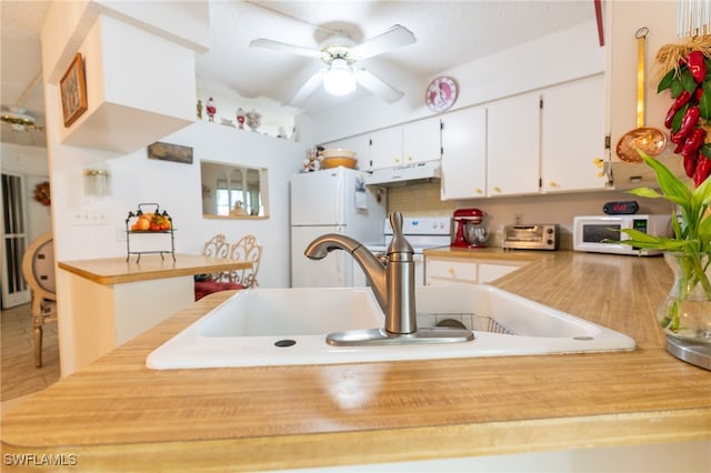 kitchen with white cabinetry, sink, ceiling fan, and white appliances