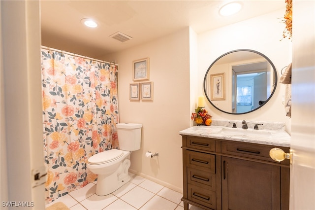 bathroom featuring tile patterned flooring, vanity, and toilet