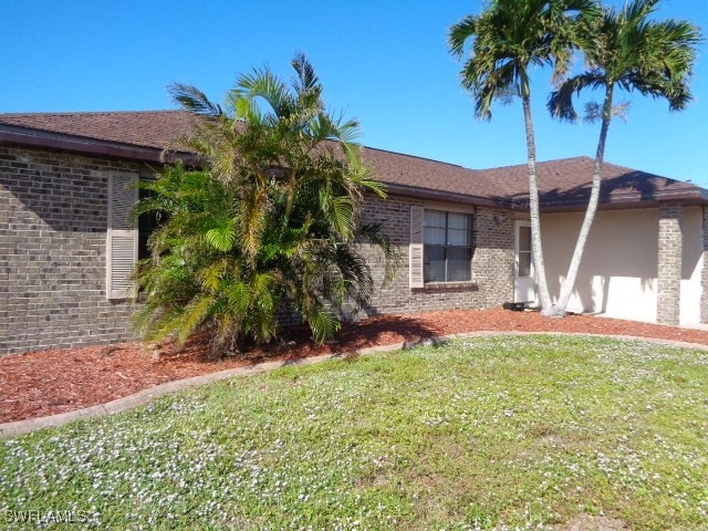 view of side of home with a lawn