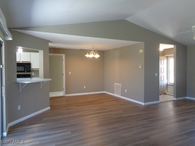 unfurnished living room featuring dark hardwood / wood-style flooring, ceiling fan with notable chandelier, and lofted ceiling