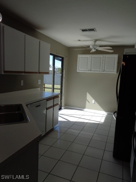 kitchen featuring black refrigerator, ceiling fan, dishwasher, white cabinets, and light tile patterned flooring